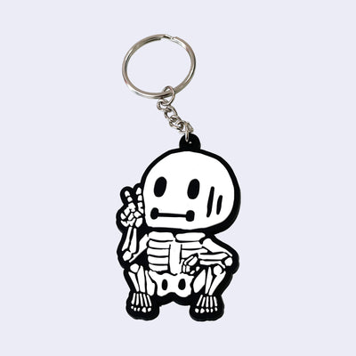 Keychain with a cartoon skeleton design on a light gray background