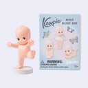Kewpie mini figurine with packaging on a light blue background