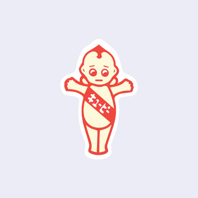 Red outlined die cut sticker of a Kewpie baby, a pastel yellow color with a red sash that has Kanji on it. The baby's arms are raised, making a T with its body.