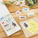 Sticker sheet with animal designs on a wooden surface with flowers