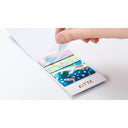 Colorful sticky notes with designs and 'KITTA' branding on a white surface.
