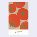 A vertical booklet with a pattern of red tomatoes with green stems on a light brown kraft-paper background, with the name 'KITTA' in gold text on a white band at the bottom, shown against a light gray background.