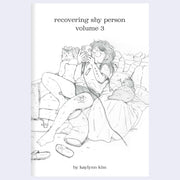 Book cover of 'recovering shy person volume 3' by kaylynn kim with an illustration of a person sitting on a couch looking at their phone.