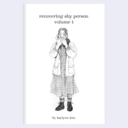 Booklet cover for "Recovering Shy Person Volume 1", with title text and a graphite illustration of a girl wearing a dress and standing with her phone in front of her face.