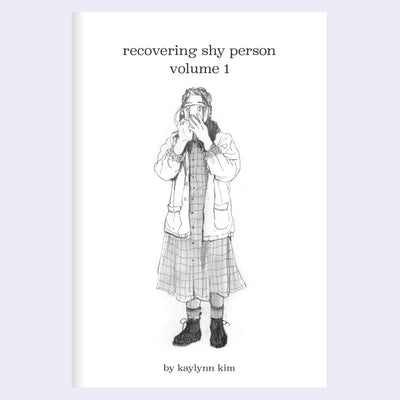Booklet cover for "Recovering Shy Person Volume 1", with title text and a graphite illustration of a girl wearing a dress and standing with her phone in front of her face.