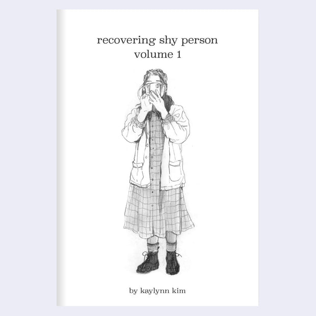 Booklet cover for "Recovering Shy Person Volume 1", with title text and a graphite illustration of a girl wearing a dress and standing with her phone in front of her face.