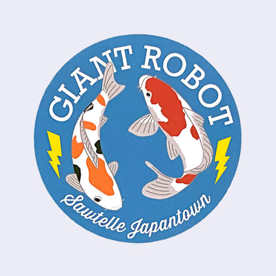 Blue circular sticker of 2 koi fish, swimming in a circle. Around them, reads "Giant Robot" above and "Sawtelle Japantown" below.