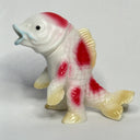 Decorative fish figurine with red and white pattern on a light gray background