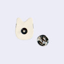 Back view of a ceramic pin with a metal pin and backing.