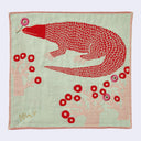 Sage green square handkerchief featuring graphic of a red Komodo dragon, holding a pink flower with its tongue. Below it are small pink trees with many branches and red circular flowers.