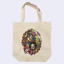 Beige tote bag featuring a colorful illustration of two stylized faces, with light beams shooting out of their eyes with decorative elements around it.