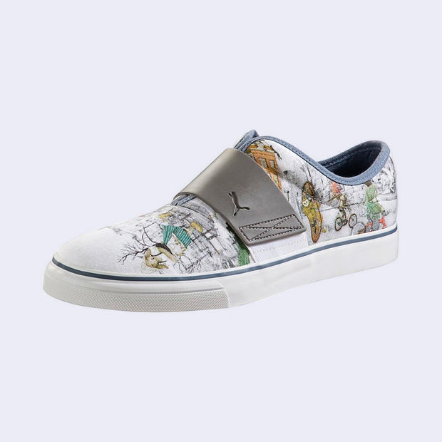 A slip on white sneaker with various illustrations printed on the canvas surface. Illustrations are by Kozyndan, using imagery of Amsterdam cityscapes and animals.