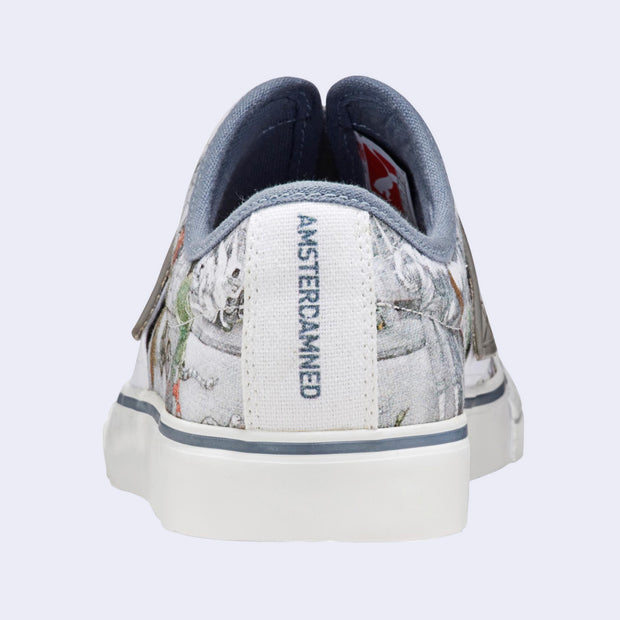 A slip on white sneaker with various illustrations printed on the canvas surface. Illustrations are by Kozyndan, using imagery of Amsterdam cityscapes and animals. Back reads "Amsterdamned."