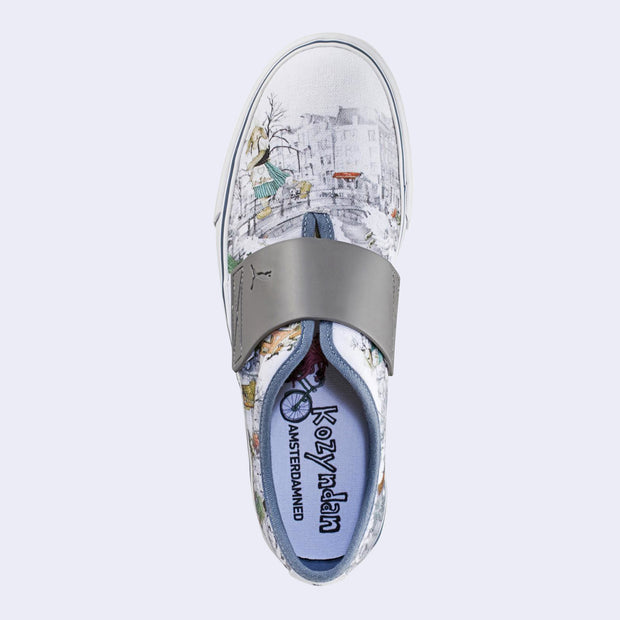 A slip on white sneaker with various illustrations printed on the canvas surface. Illustrations are by Kozyndan, using imagery of Amsterdam cityscapes and animals.