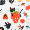Close up of sticker sheets with illustrations of black cats.