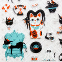 Close up of sticker sheets with illustrations of black cats.
