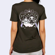 Greyish black t-shirt, back view. Features a graphic that takes up most of the width of the shirt. Sanrio's Kuromi and a skeleton sit next to one another, under a large black and purple bow that drapes around them like an archway. They sit atop a cloud.