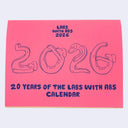Pink calendar titled "labs with abs" with a cover of cartoon lab dogs with abs forming the number "2026"