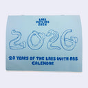 Blue calendar titled "labs with abs" with a cover of cartoon lab dogs with abs forming the number "2026"
