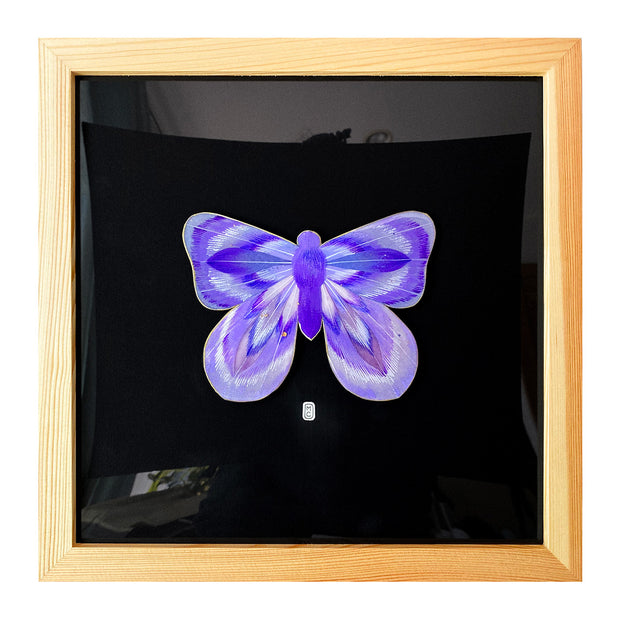 Illustration on cut out paper of a lavender butterfly with abstract striations on its swings, looking loosely psychedelic. Butterfly is mounted on black paper and in a light grain wooden frame. 