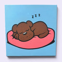 A square canvas painting of a cartoon brown sleeping puppy resting on a pink cushion with 'zzz' above it, set against a light blue background.