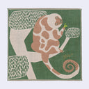 Square textile tea towel of a lemur sitting on a tree and holding a small green bug in its hand.