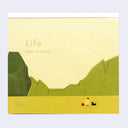 Memo pad cover with illustration of a landscape with mountains and a small figure, featuring the text 'Life' by Taku Bannai.