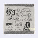 Fabric with black and white dog illustrations on a gray background, featuring the brand 'Lisa Larson'.