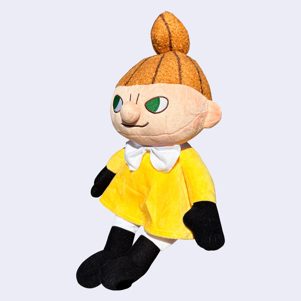 Plush doll of Little My, a character with a mischievous look, a tall orange ponytail and a yellow dress.