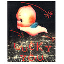 Screenprint of a lit up city at night, seen from overhead and far away as if in a plane. A large Kewpie baby flies overhead, with red shooting stars and pixilated text that reads "Lucky You."