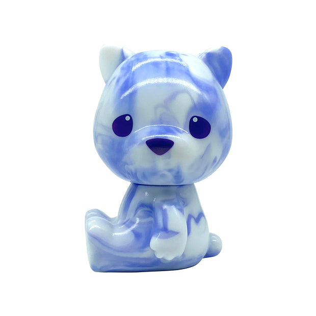 Small sofubi bear with a large head, purple with white marbling. They sit on the floor with large eyes and a nose and no other defining facial features.