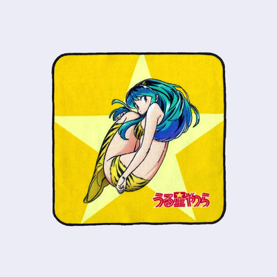 Rounded edge square towel featuring Lum, from Urusei Yatsura, slightly curled up in a ball and looking back at the viewer. The show logo is in bottom right and the background is yellow with a large yellow star.