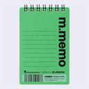 A green spiral-bound notepad with black wire binding, featuring the vertical text 'm.memo' and lined writing space on a light gray background.