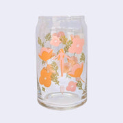 Glass cup with a flat base and slightly inward lip. A pink simply shaped woman with orange hair and no body or facial detailing stands small in the center, surrounded by same colored poppy flowers and green weed like greenery.