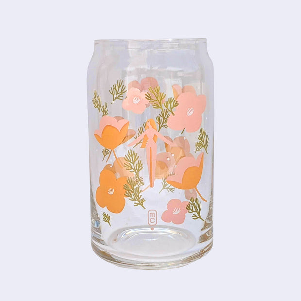 Glass cup with a flat base and slightly inward lip. A pink simply shaped woman with orange hair and no body or facial detailing stands small in the center, surrounded by same colored poppy flowers and green weed like greenery.