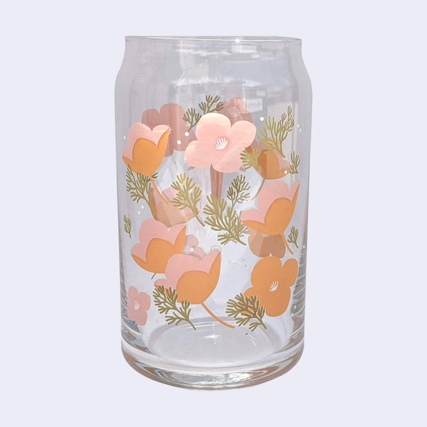 Glass cup with a flat base and slightly inward lip. Pastel pink and oranges with white detailing are on the glass, with greenery accenting.