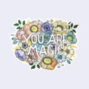 Die cut sticker of a muted colored bouquet, with many illustrated flowers and leaves. Text in the center reads "You are magic"