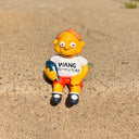 Figure of Martin Prince from The Simpsons, wearing a shirt that says "Wang Computers", sitting and holding a book at his side. 