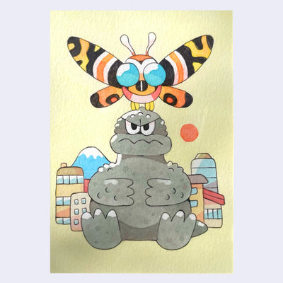Illustration of a cute Godzilla, sitting on the ground in front of a small city. He has an angry expression and arms on his stomach. Atop his head is a cute Mothra.