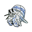 Die cut wooden painting of a hermit crab, white with gold spikes.  It has a cracked bucket on its back with blue porcelain style paintings on it all. 