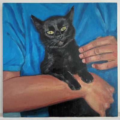 Painting of a black cat being held by a person wearing a blue shirt.