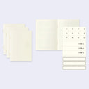 Set of cream-colored paper notebooks with gridded paper and an additional sticker sheet with numbers and "idea" stickers.
