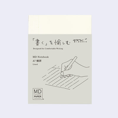 MIDORI MD Notebook in A7 sizing with a sleeve featuring a hand holding a pen illustration and some specs.