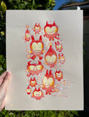 Illustration of many small, cute cartoon devil characters with small stars around them. Held in someone's hand against greenery.