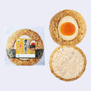 A packaged and unpackaged round rice ball snack shown on a light gray background, actually stationery. The left side shows the sealed product package with Japanese text and a photo of the inside; the right side shows the snack opened into two halves, revealing a halved soft-boiled egg, nori seaweed, and plain rice.
