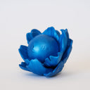Blue flower-shaped object with a spherical center that has a calm, closed eye face.