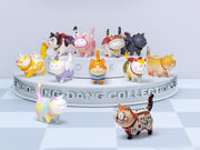 Collection of colorful cat figurines on a stand with 'Miao Ling Dang Collections' branding.