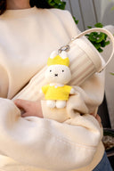 Plush keychain of Miffy wearing a yellow dress with a white collar and a yellow crown.
