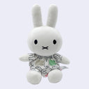 Plush Miffy doll, sitting with a patterned shirt dress of repeating Miffy heads.