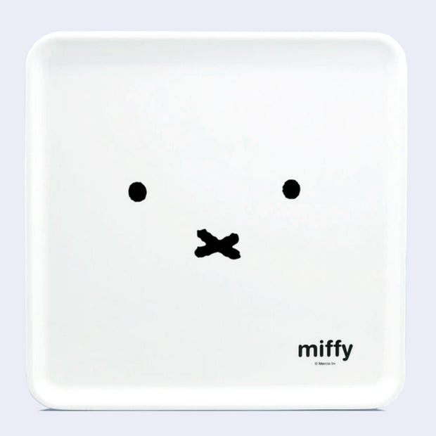 White square serving tray with a design of Miffy's face, close up so only her eyes and mouth are visible. In small text in the bottom right reads "Miffy"
